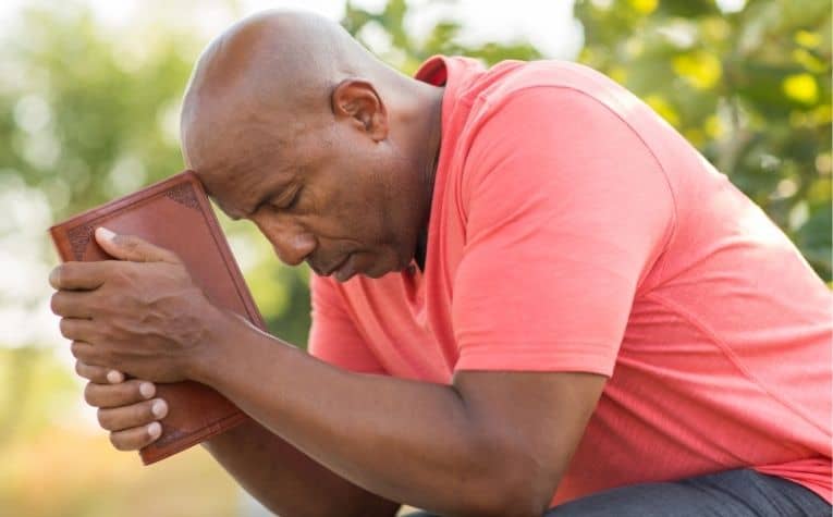 man reading a devotional Bible